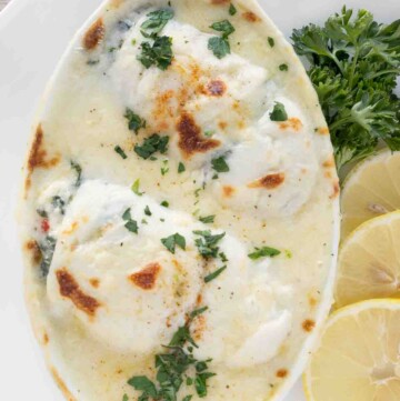 baked stuffed flounder in a white casserole dish