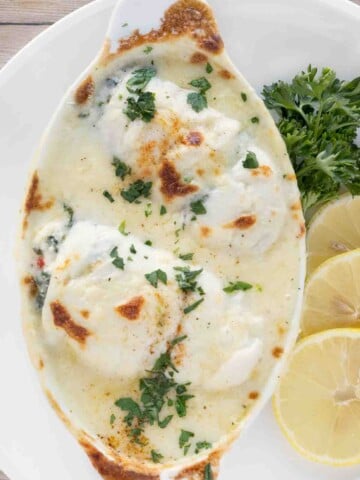 baked stuffed flounder in a white casserole dish