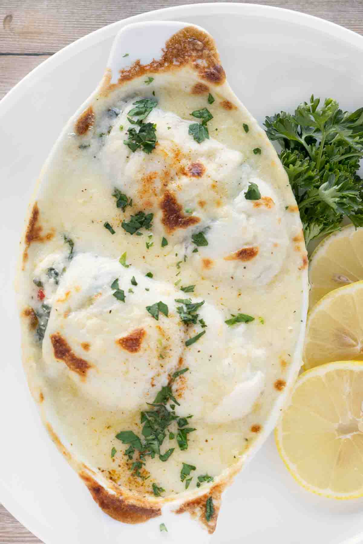 baked stuffed flounder in a white casserole dish