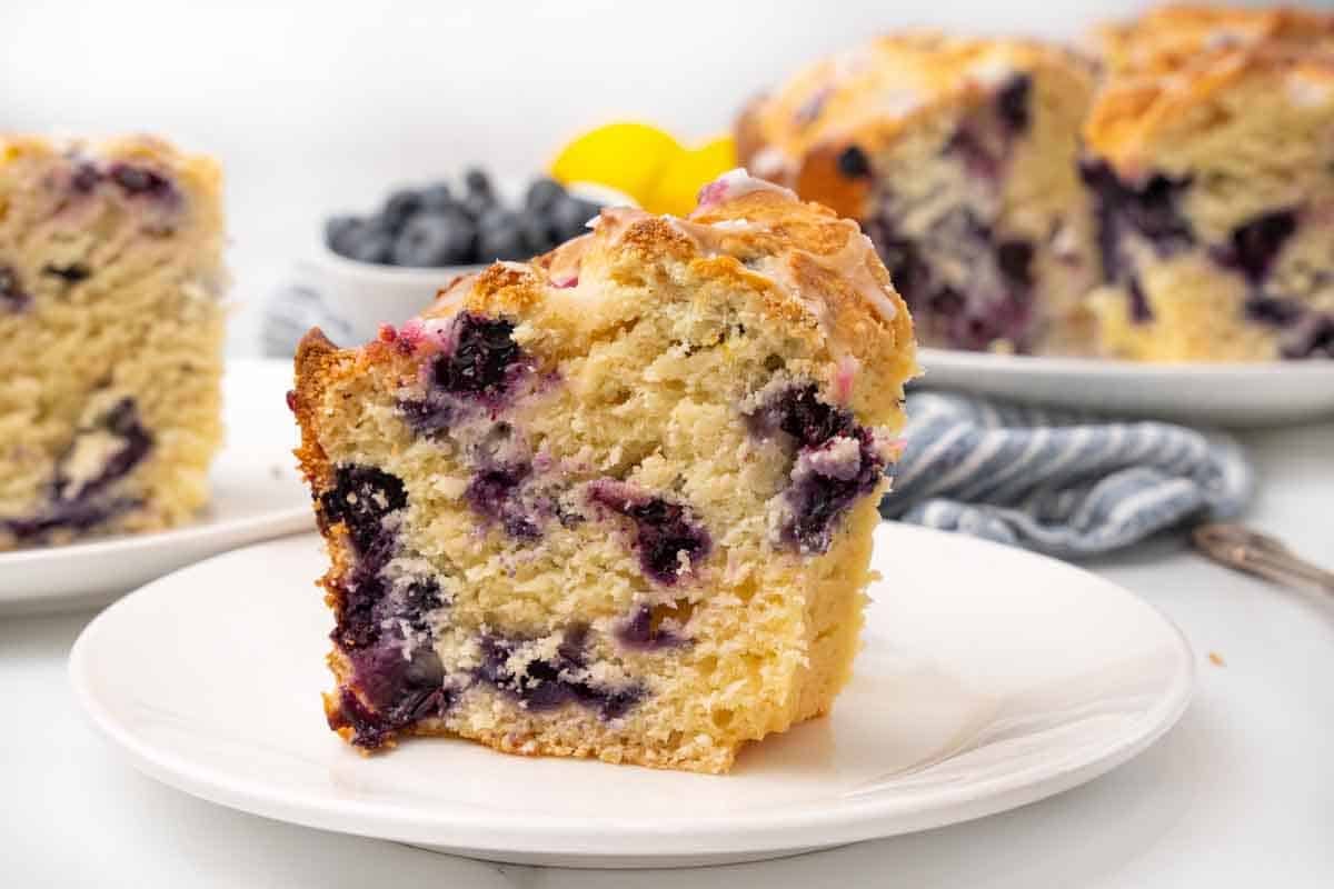 Slice of lemon blueberry pound cake on a white plate.