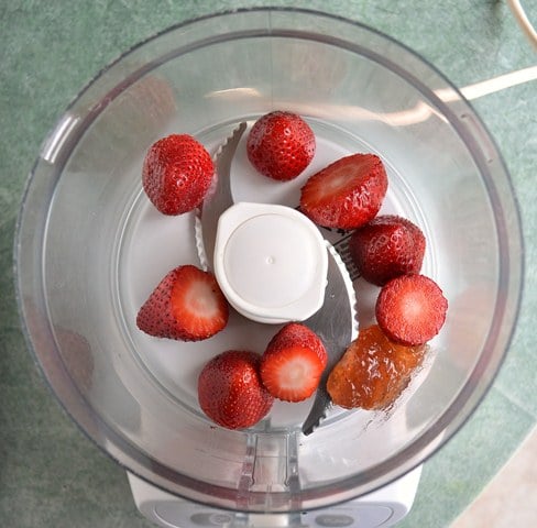 strawberries and sugar in a food processor
