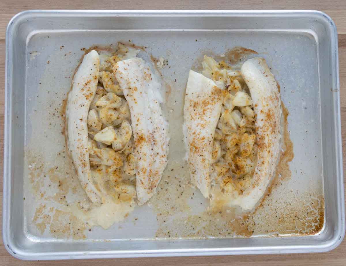 cooked stuffed flounder on a small sheet pan