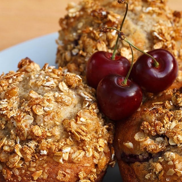 3 cherry vanilla muffins on a white plate