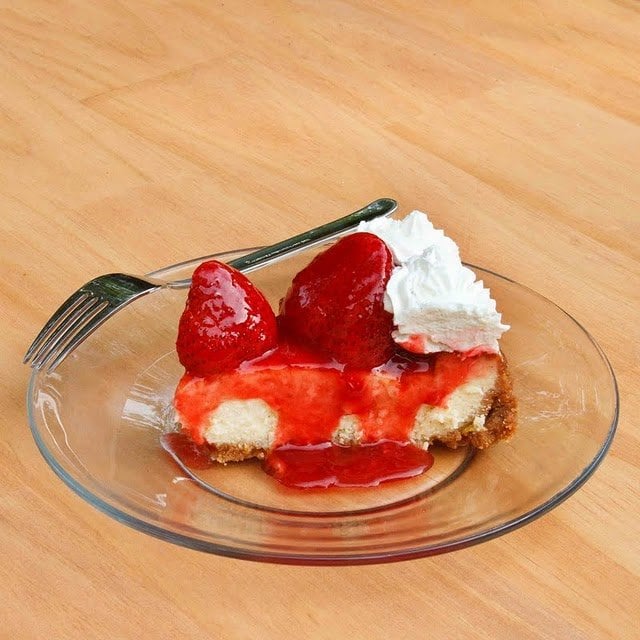 slice of Mascarpone Strawberry Cheesecake on a glass plate