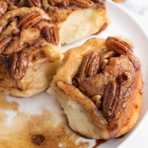 caramel pecan bun being taken out of the group of buns
