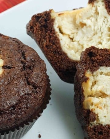 Chocolate and cheesecake muffins sitting on a white plate