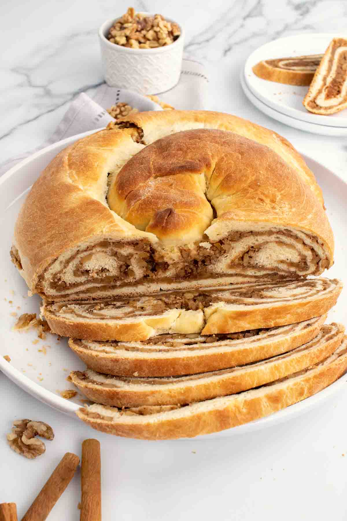 slices of potica in front of the loaf on a white plate