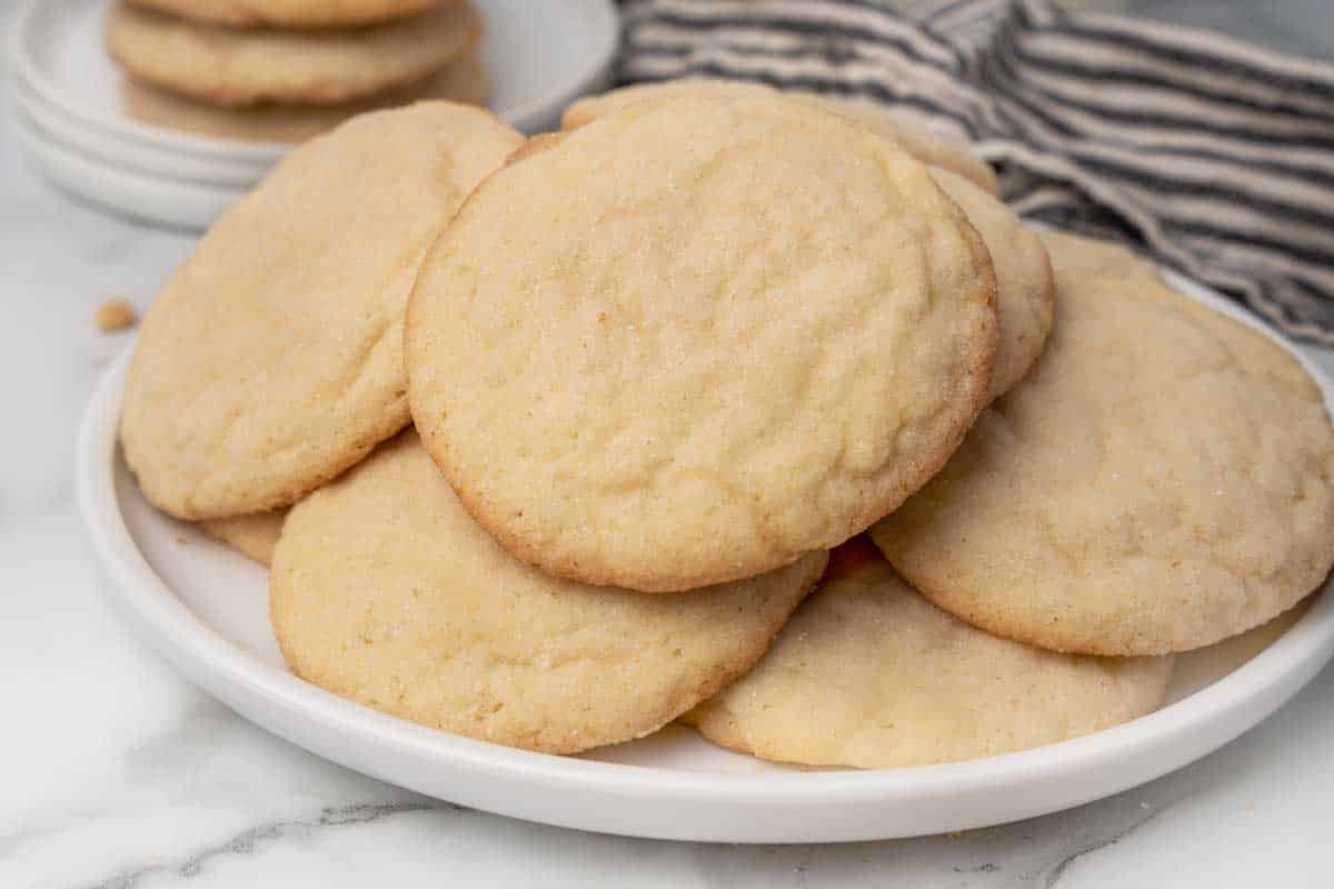 pile of sugar cookies on a white plate