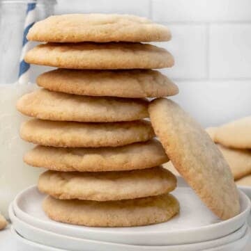 stack of sugar cookies on a white plate