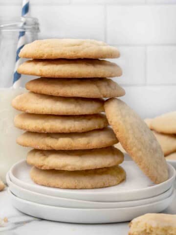 stack of sugar cookies on a white plate