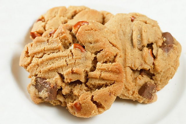 3 peanut butter toffee pretzel cookies sitting on a white plate
