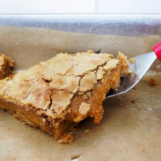 cinnamon toffee blondie on a spatula with a red handle
