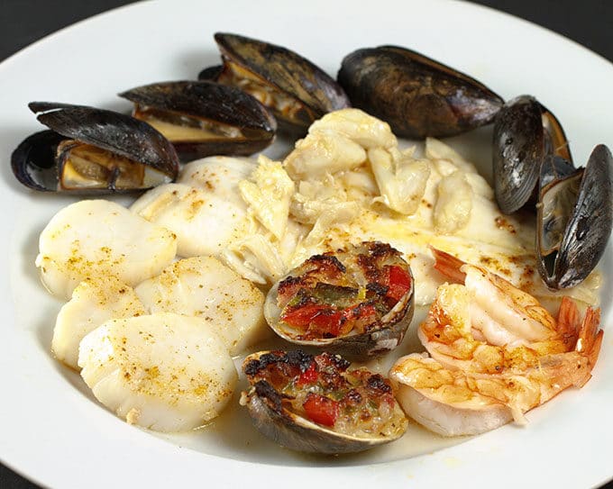 broiled seafood combination on a white plate