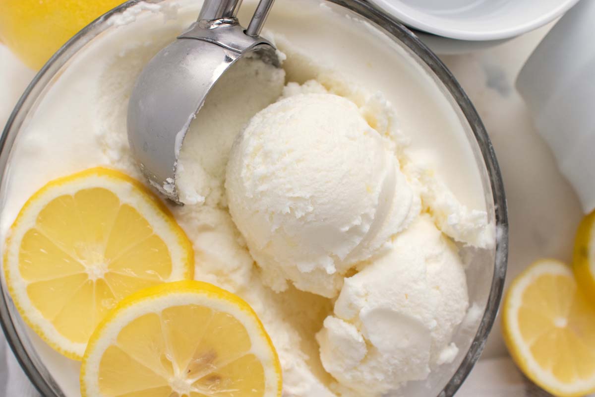 scooping lemon gelato out of a bowl