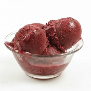 glass bowl of scoops of blackberry gelato