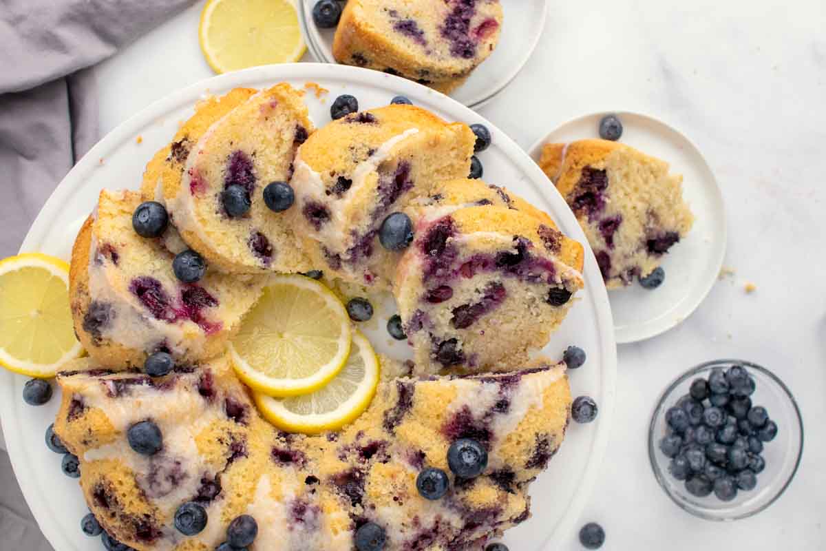 gluten free blueberry pound cake sliced  on a white platter