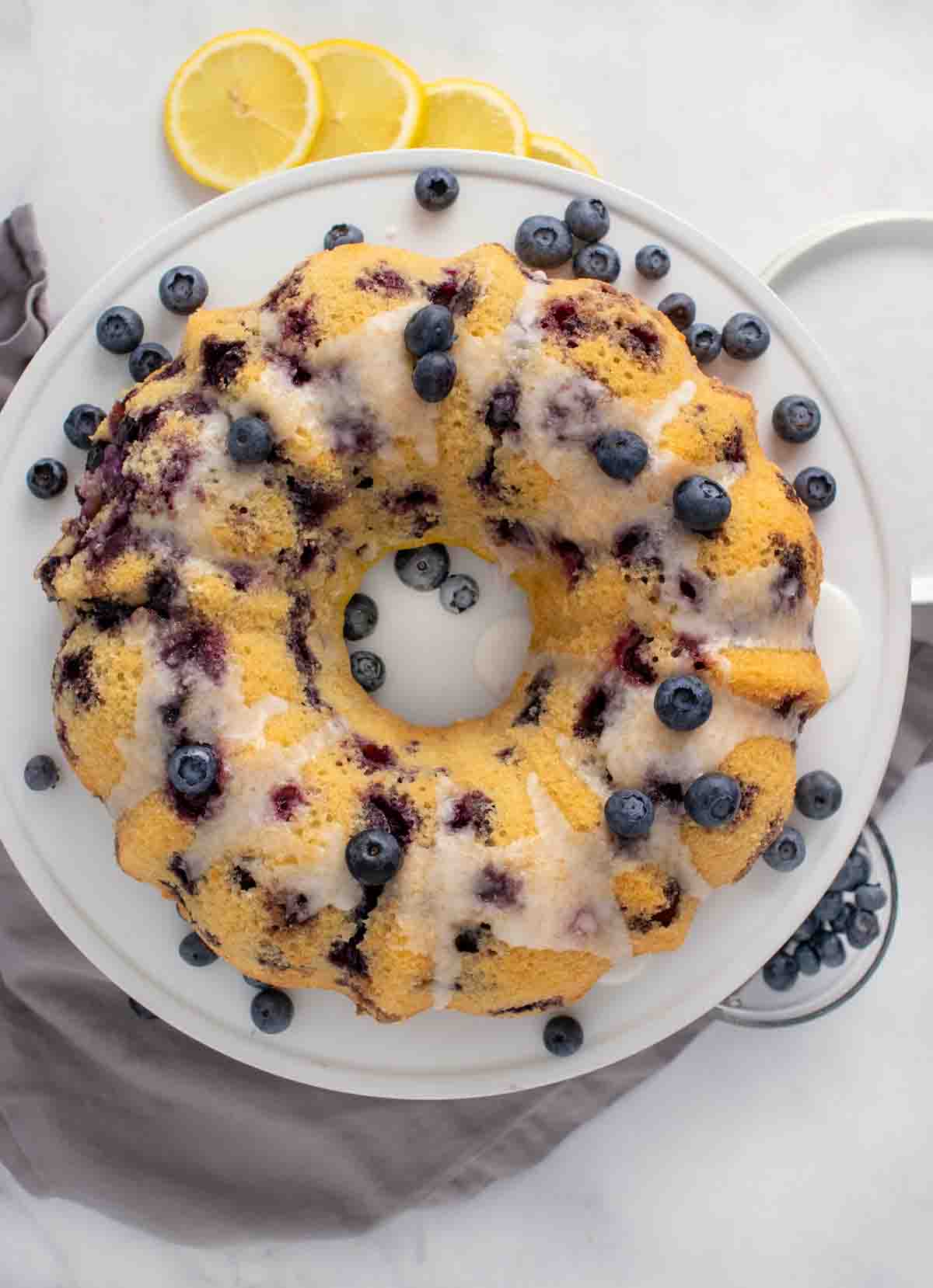 unsliced gluten free blueberry pound cake on a white platter