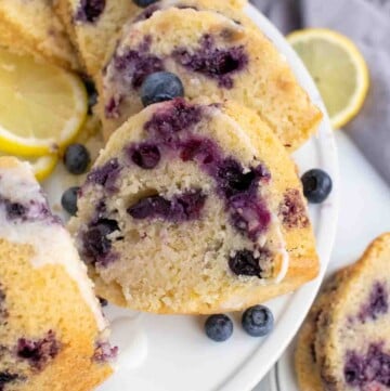 slices of blueberry lemon pound cake on a white platter