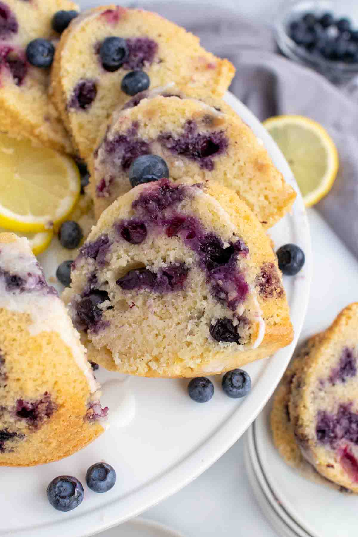 slices of blueberry lemon pound cake on a white platter