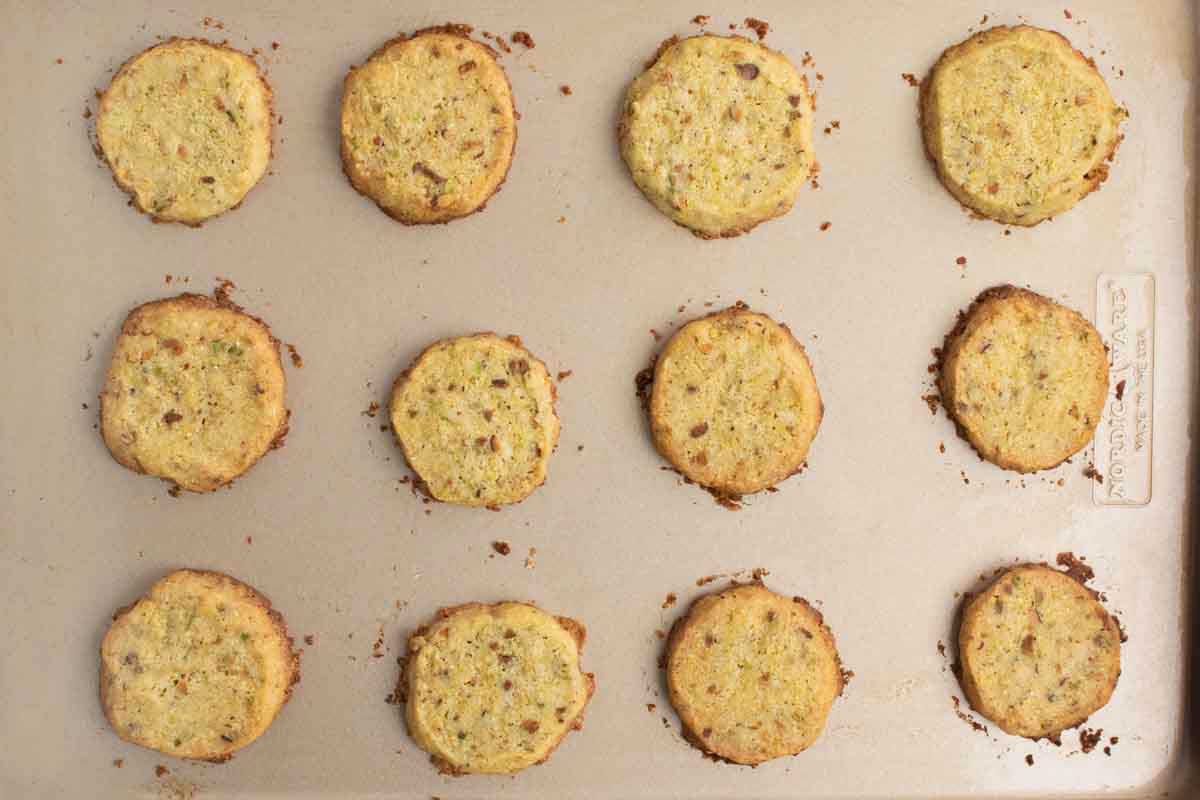 baked pistachio cornmeal cookies on a baking sheet