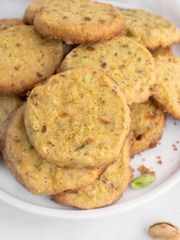 cornmeal pistachio butter cookies on a white plate