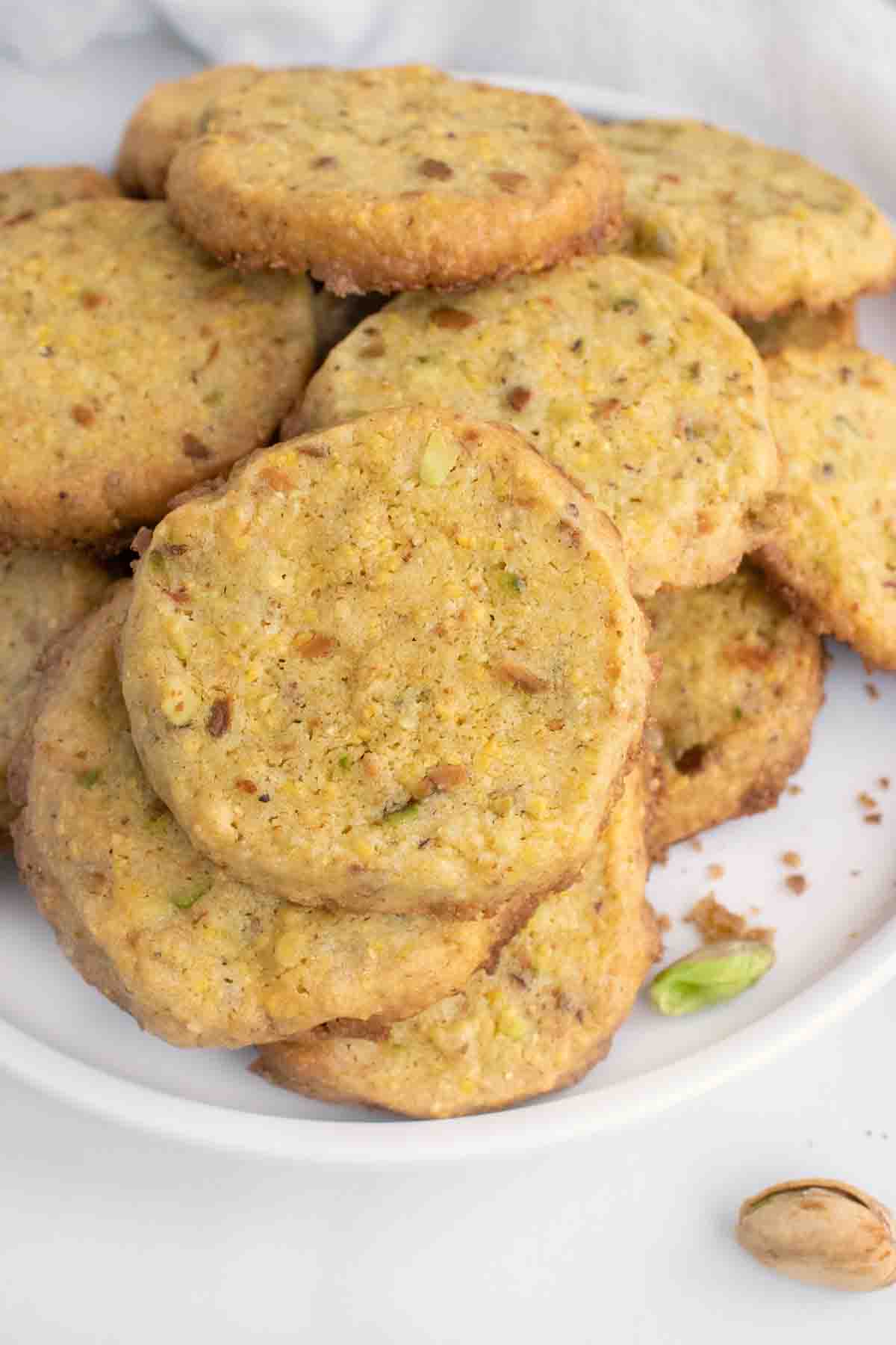 cornmeal pistachio butter cookies on a white plate