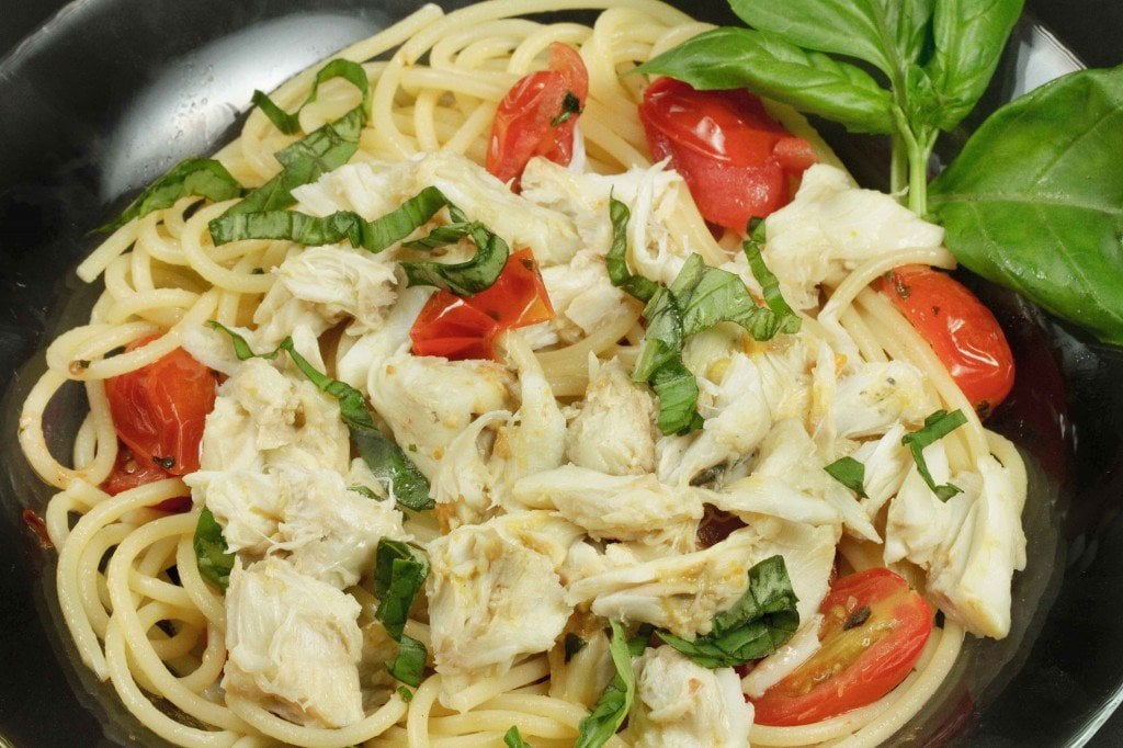 pasta topped with jumbo lump crabmeat, basil and tomatoes