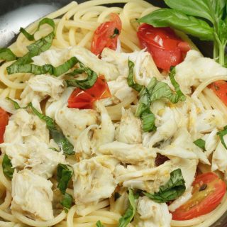pasta topped with jumbo lump crabmeat, basil and tomatoes