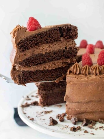 slice of chocolate mousse cake being taken out of whole cake