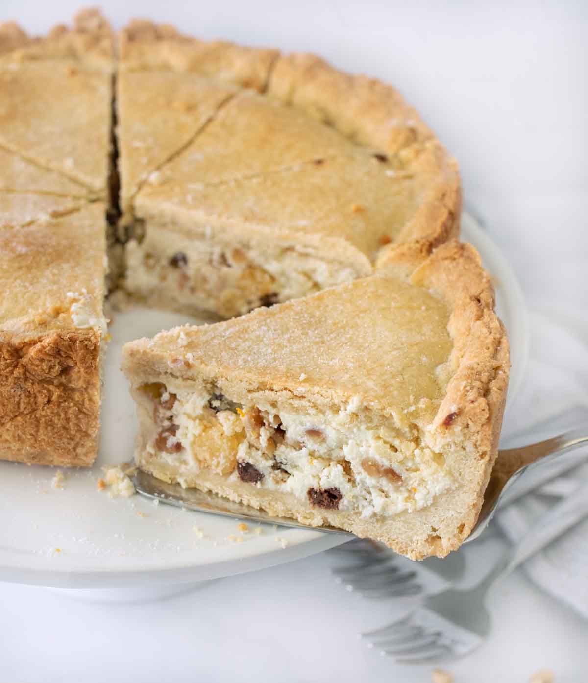 slice on a pie spatula being taking out of whole cake