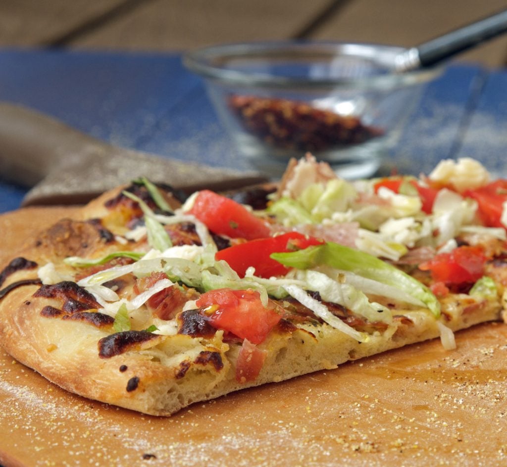 slice of Italian Hoagie Pizza on a pizza peel