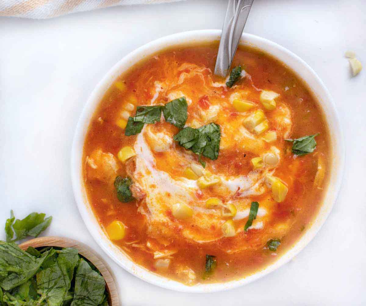 roasted red pepper soup in a white bowl.