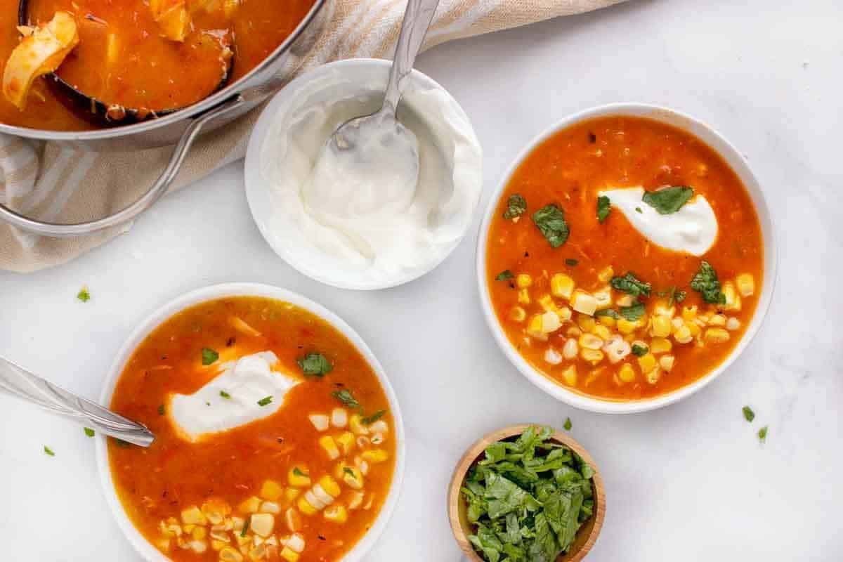 two bowls of roasted red pepper soup.