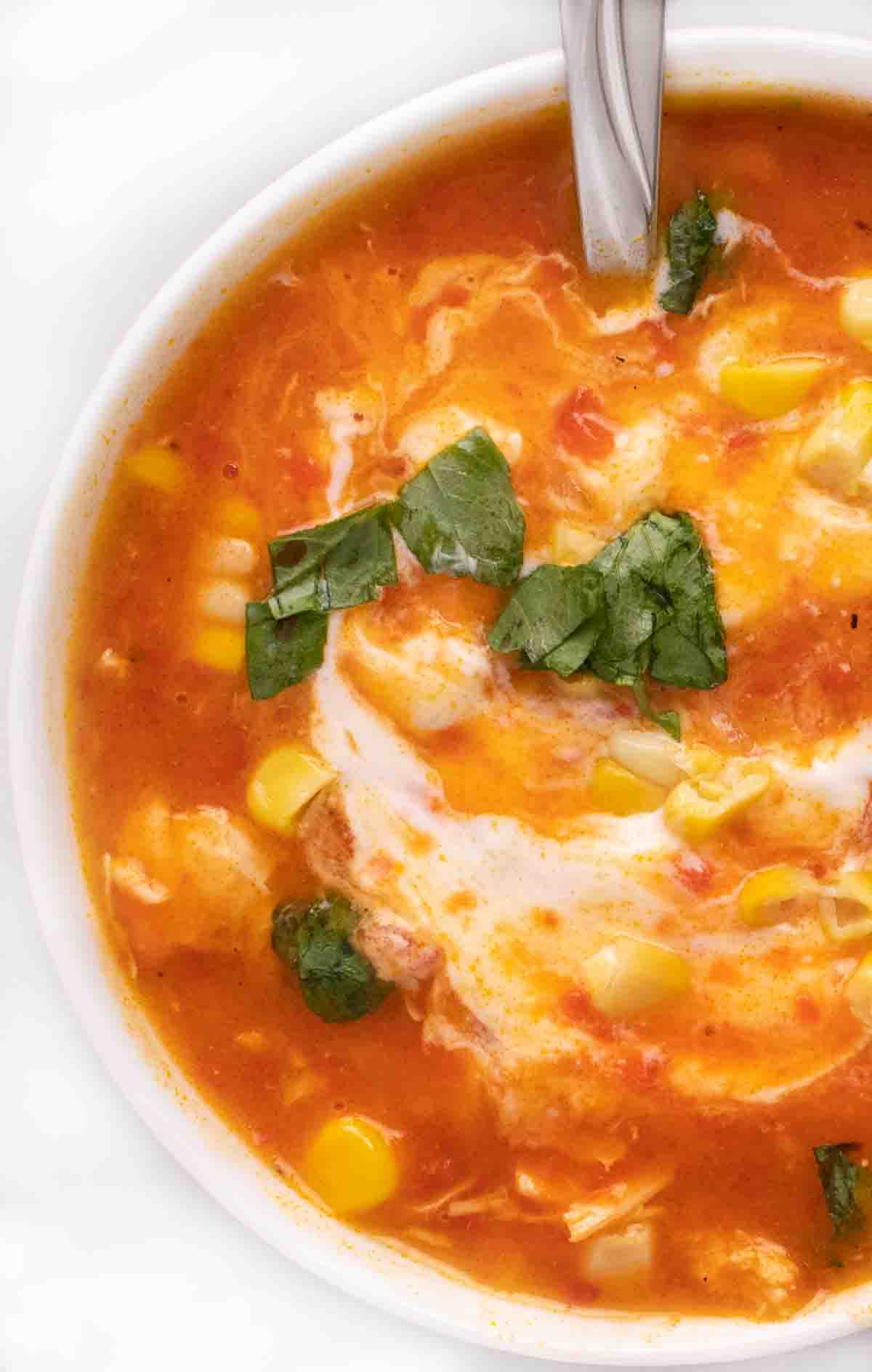 roasted red pepper soup in a white bowl.