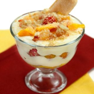 glass dish of peach tiramisu with a lady finger sticking out