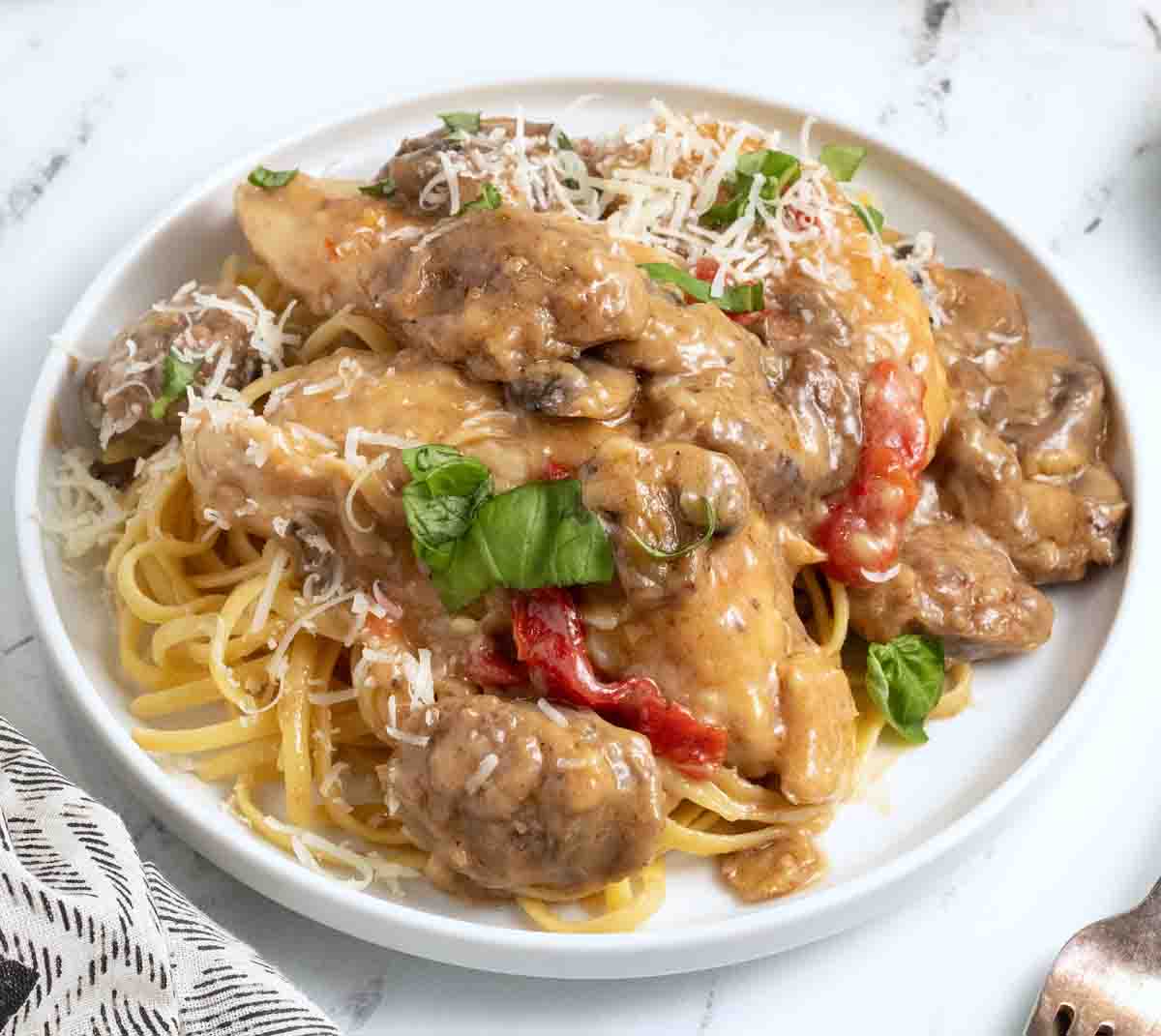 Tuscan chicken and sausage on a white plate