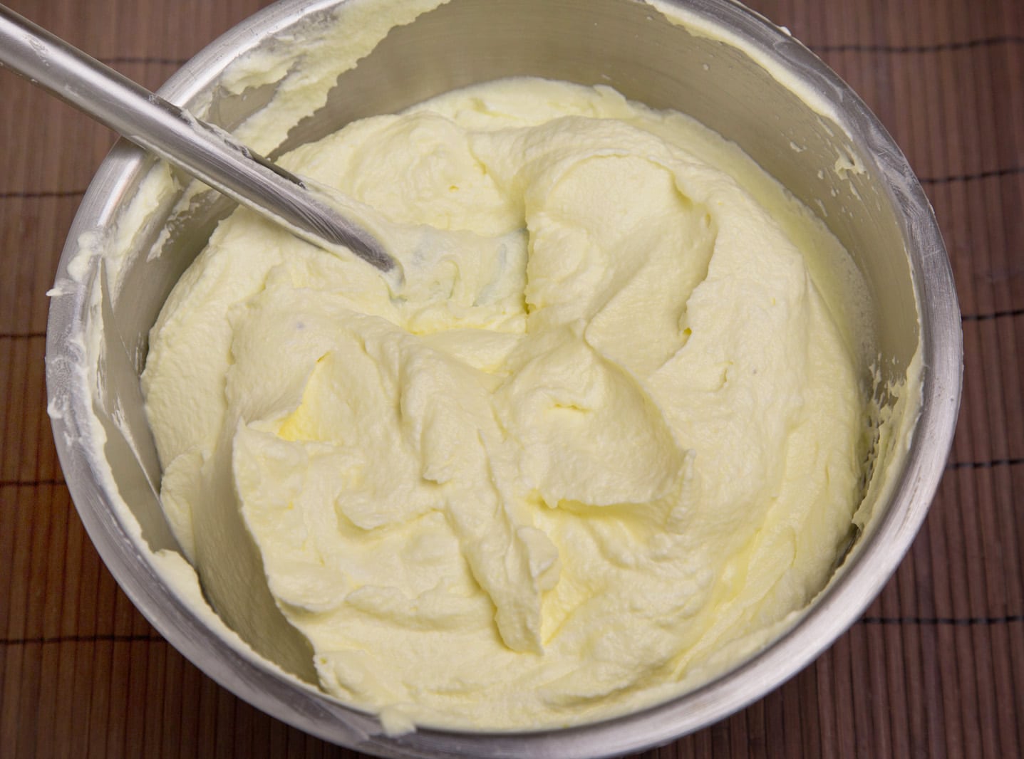 tiramisu cream in a bowl with a spatula sticking out