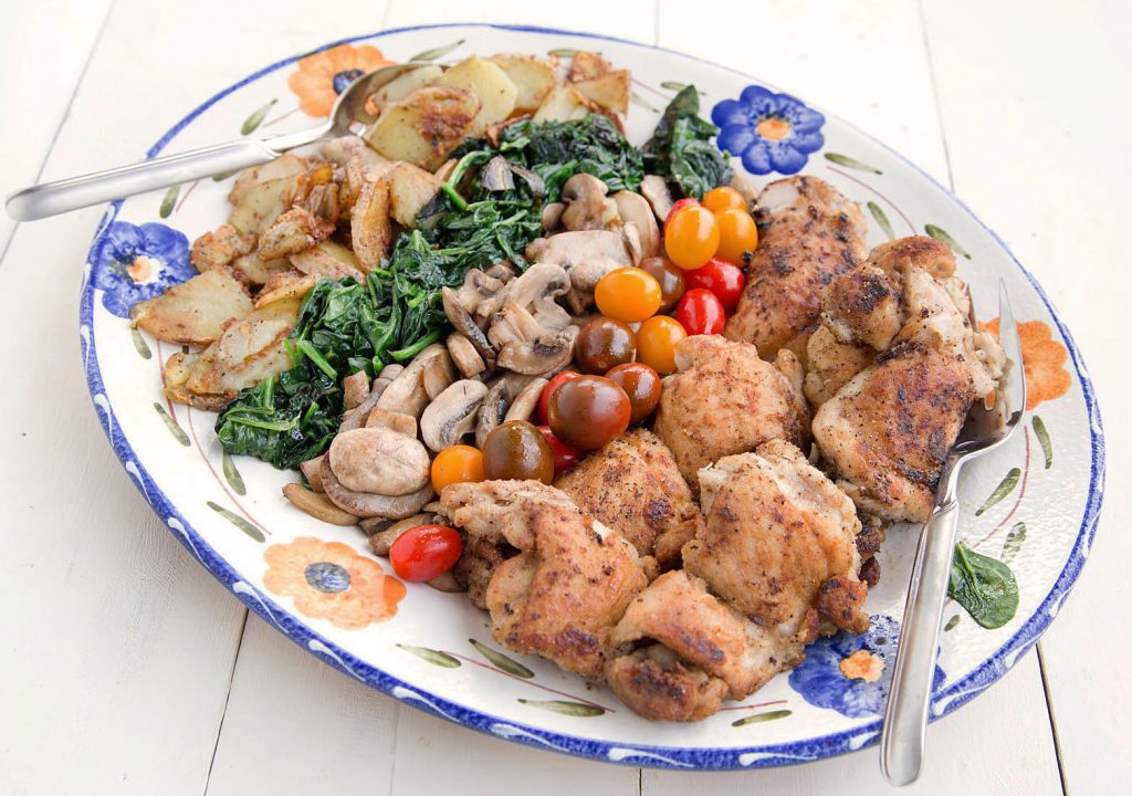 Seared Chicken with fried potatoes, sauteed spinach, mushrooms and heirloom grape tomatoes