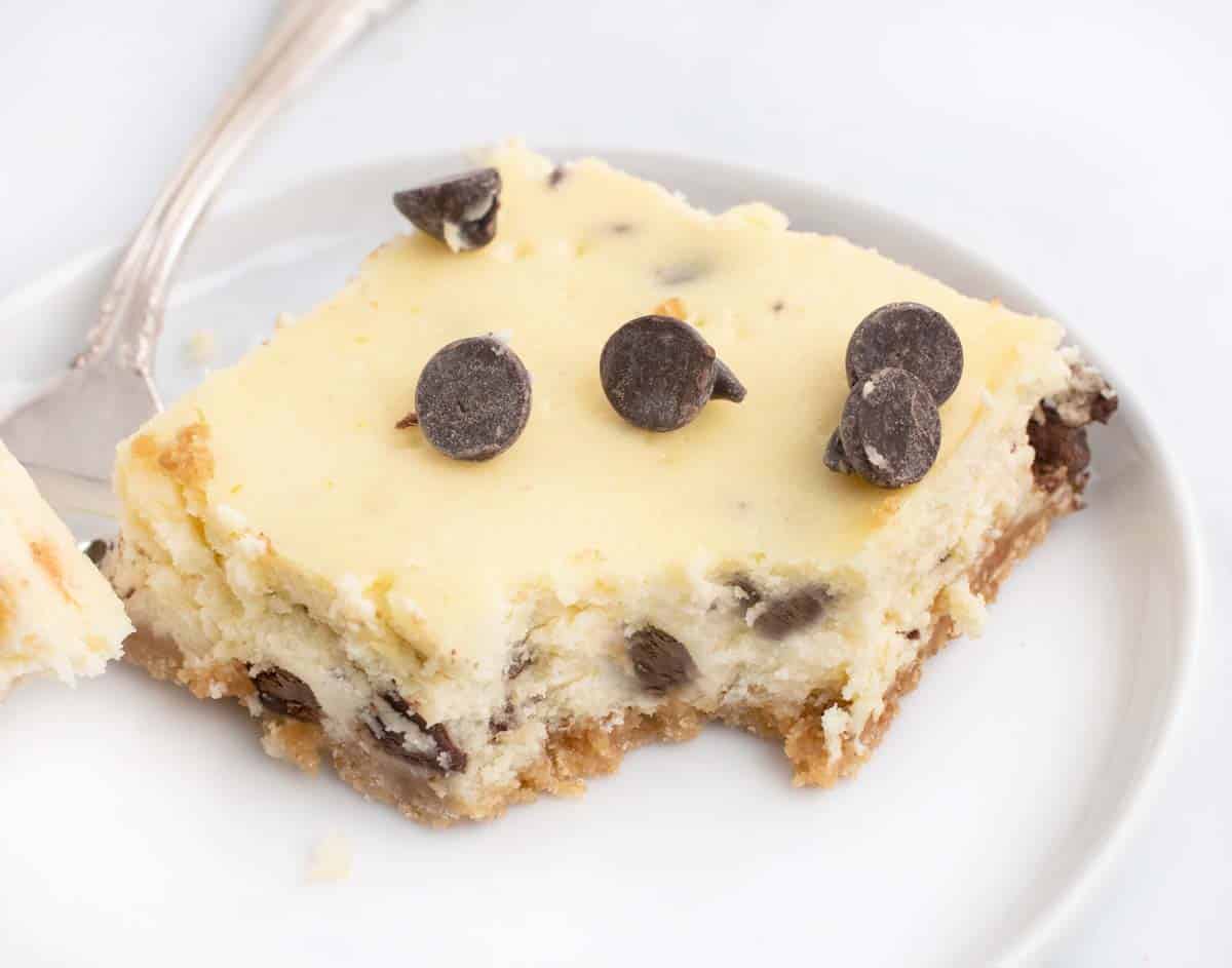 close up of chocolate chip cookie bar with a fork full taken out