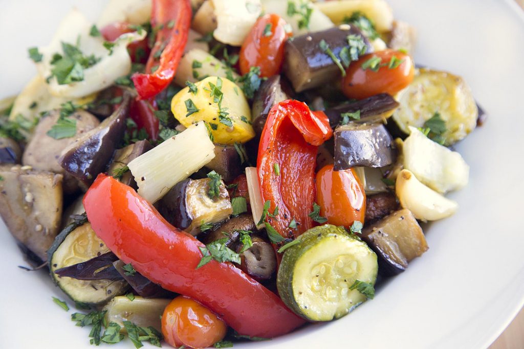 Mediterranean style (roasted vegetables) ratatouille in a white bowl. 
