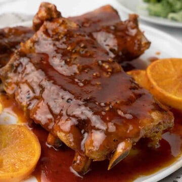 close up of slow cooker bbq ribs on white plate