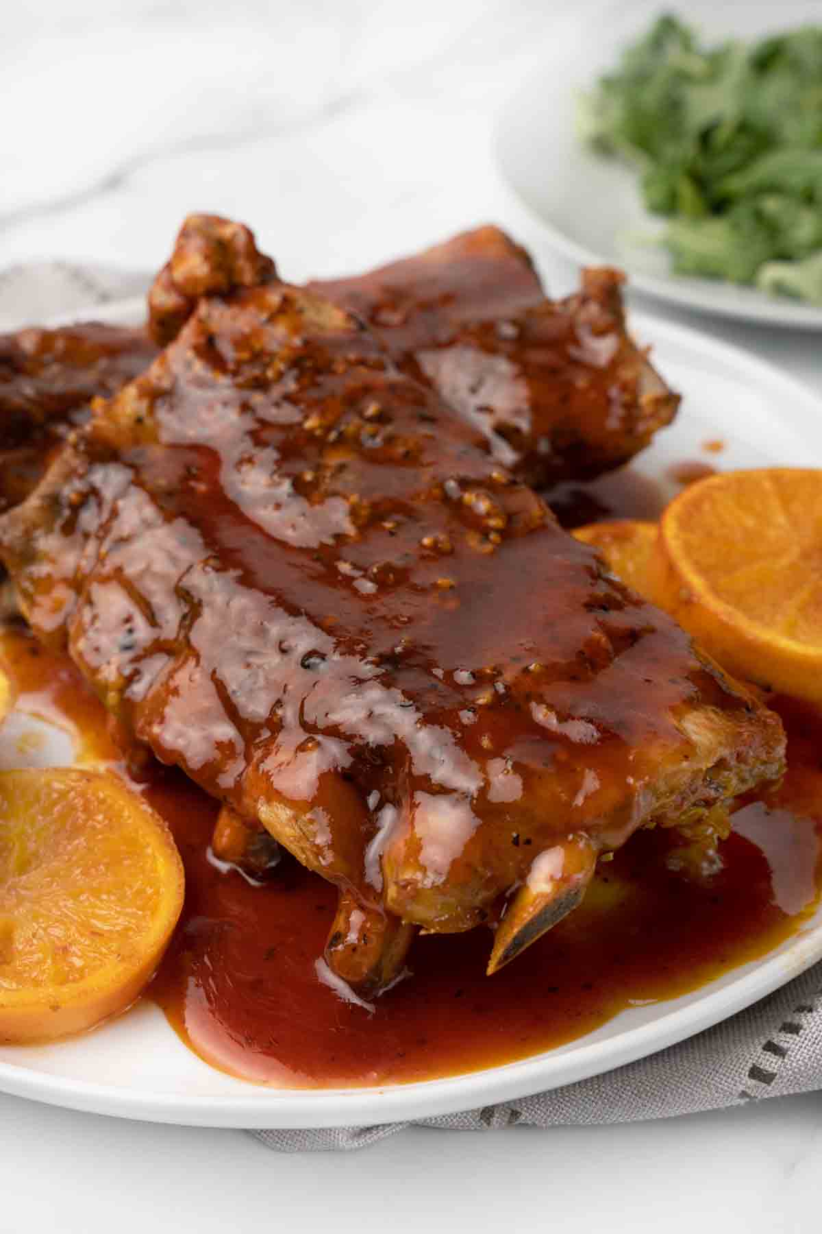 close up of slow cooker bbq ribs on white plate