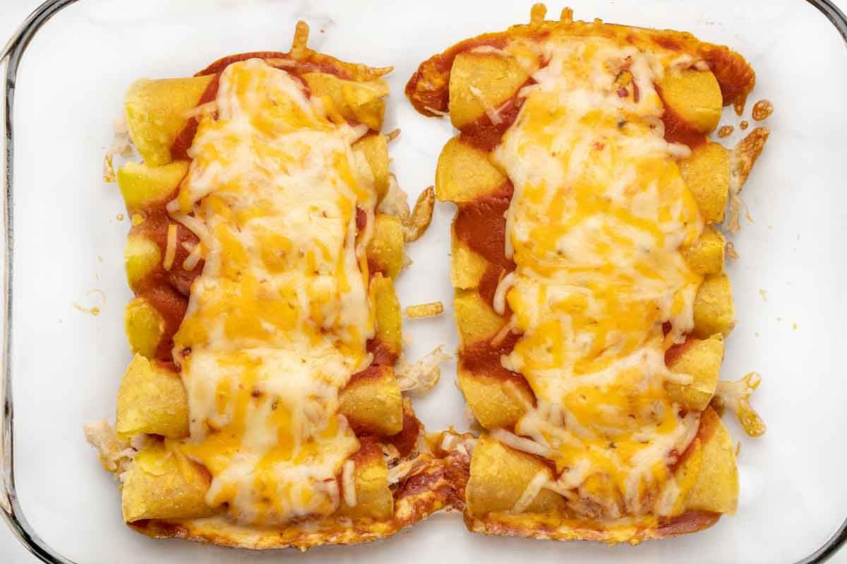 Cooked enchiladas in baking dish.