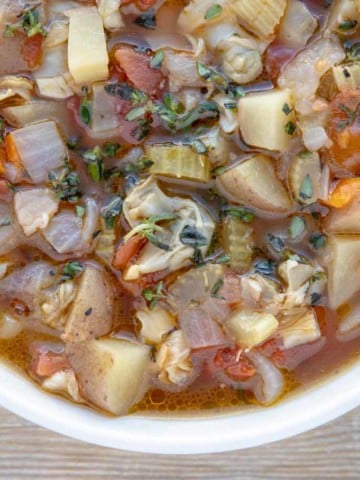 overhead partial shot of manhattan clam chowder in a bowl