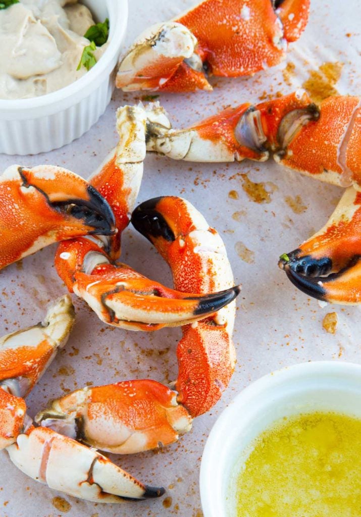overhead view of Jonah crab claws with mustard dip and melted butter