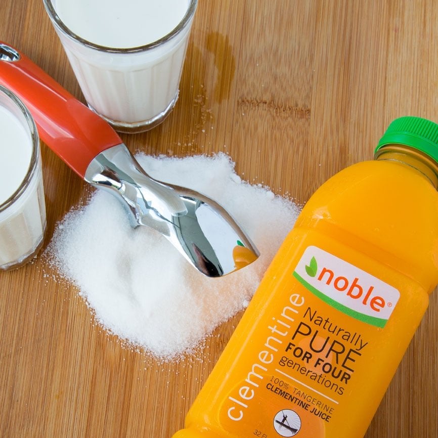 ingredients to make tangerine gelato on a wooden cutting board