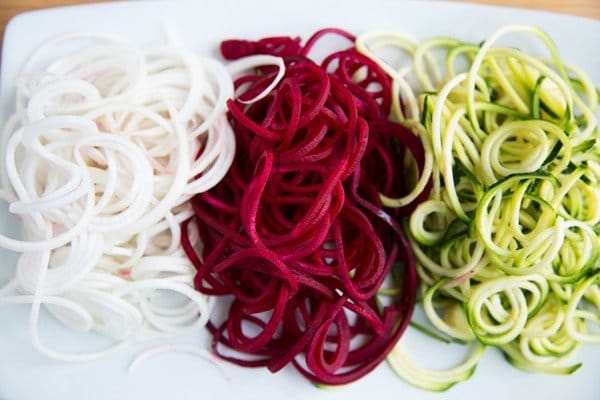 overhead view of Zucchini noodles, Turnip Noodles, Beet Noodles on a white plate