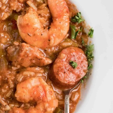 overhead partial view of Jambalaya in a white bowl with a spoon