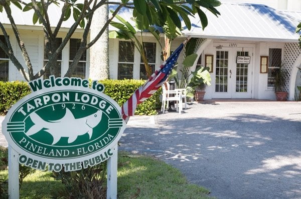 Welcome to Tarpon Lodge sign in front of the building