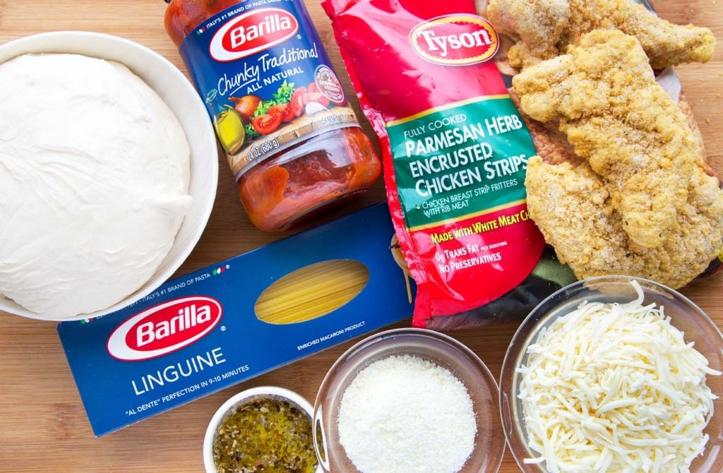 Ingredients to make a chicken parm pizza